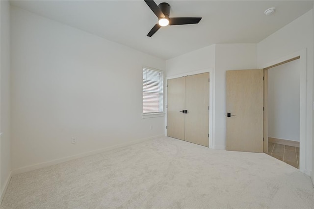 unfurnished bedroom with ceiling fan, a closet, and carpet