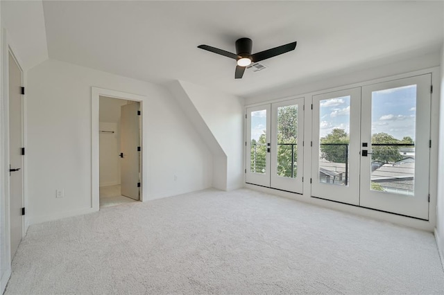 additional living space with french doors, ceiling fan, vaulted ceiling, and light colored carpet