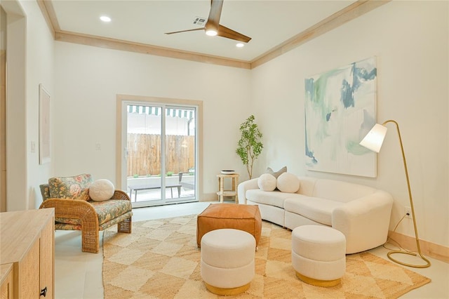 living area featuring ceiling fan and ornamental molding