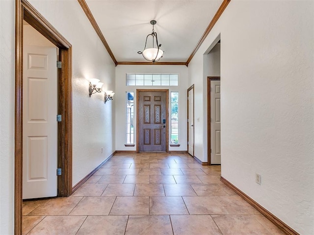 tiled foyer entrance featuring ornamental molding