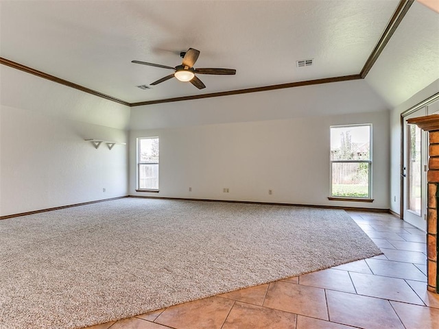 spare room featuring light tile patterned flooring, ceiling fan, vaulted ceiling, and crown molding