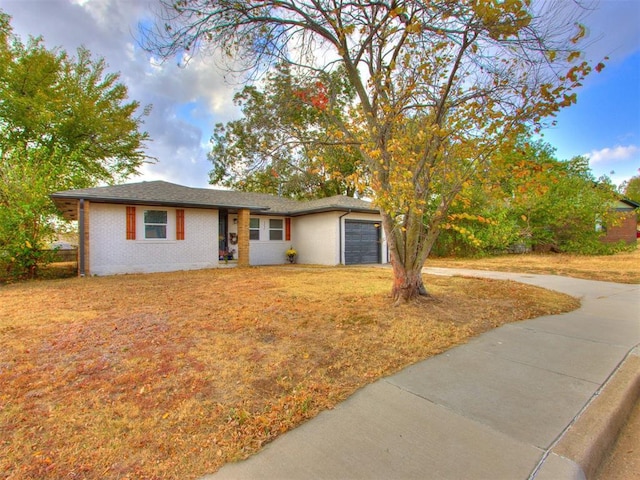 view of front facade with a front yard and a garage