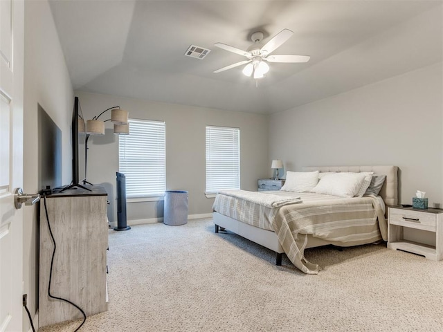 bedroom featuring ceiling fan, vaulted ceiling, and light colored carpet