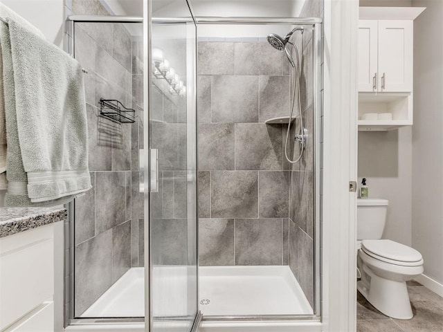 bathroom with a shower with door and toilet