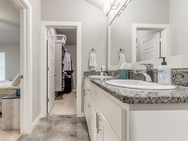 bathroom featuring tile patterned flooring and vanity