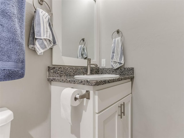 bathroom with toilet and vanity