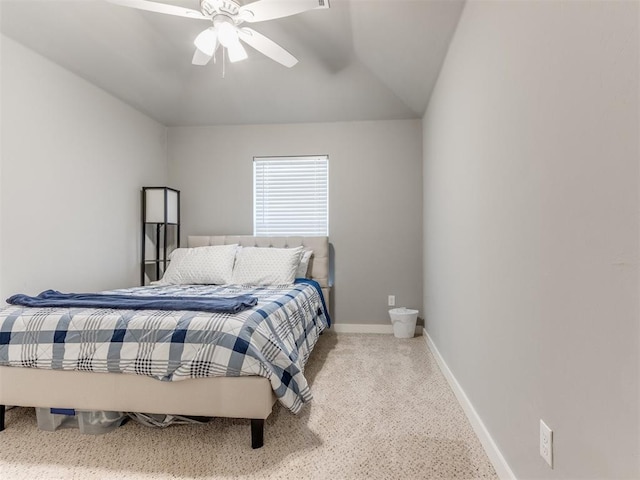 carpeted bedroom with ceiling fan and vaulted ceiling