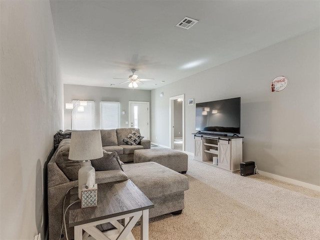 carpeted living room with ceiling fan