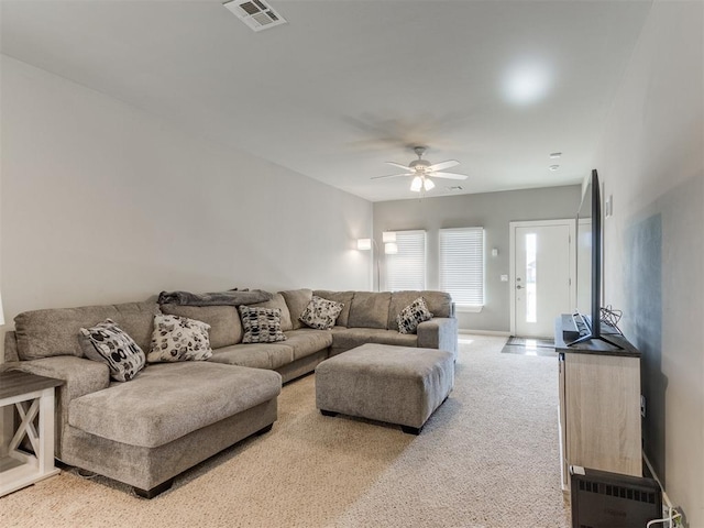 living room featuring carpet floors and ceiling fan