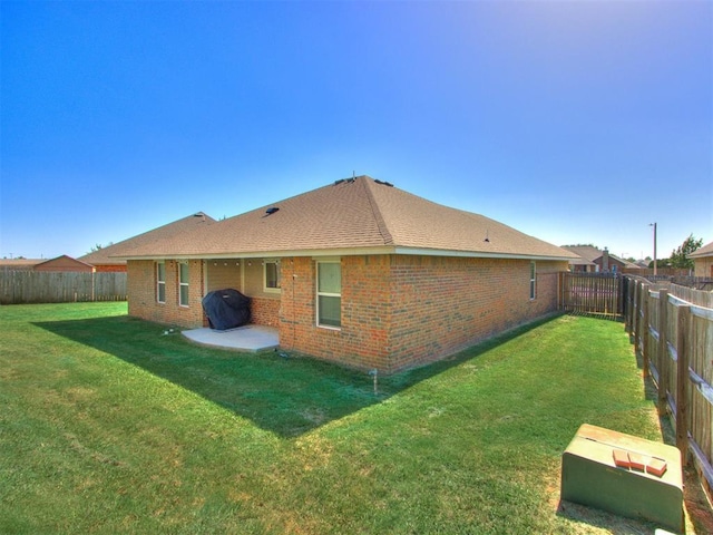 back of property featuring a lawn and a patio