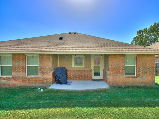 back of house featuring a yard and a patio