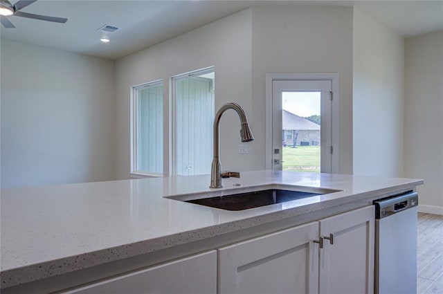 207 Hope Ave, Shawnee, OK 74804 - kitchen featuring dishwasher, light stone countertops, white cabinets, light wood finished floors, and recessed lighting