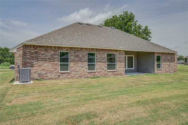 207 Hope Ave, Shawnee, OK 74804 - back of property featuring roof with shingles, a lawn, and brick siding