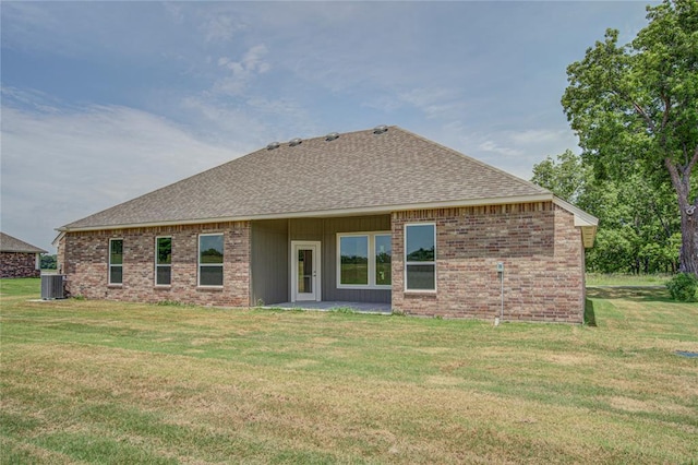 207 Hope Ave, Shawnee, OK 74804 - rear view of property with a shingled roof, a lawn, and brick siding