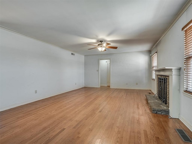 unfurnished living room with ornamental molding, ceiling fan, and light wood-type flooring