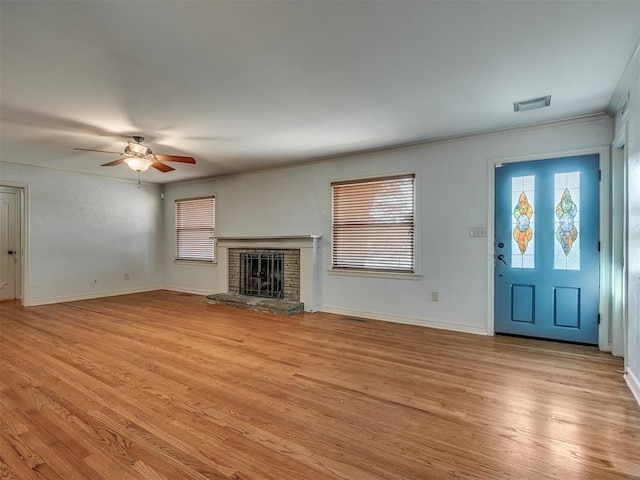 unfurnished living room with ceiling fan, light hardwood / wood-style floors, and ornamental molding