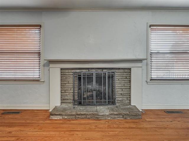 interior details featuring hardwood / wood-style floors and a stone fireplace