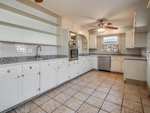 kitchen featuring stainless steel appliances, white cabinetry, and sink