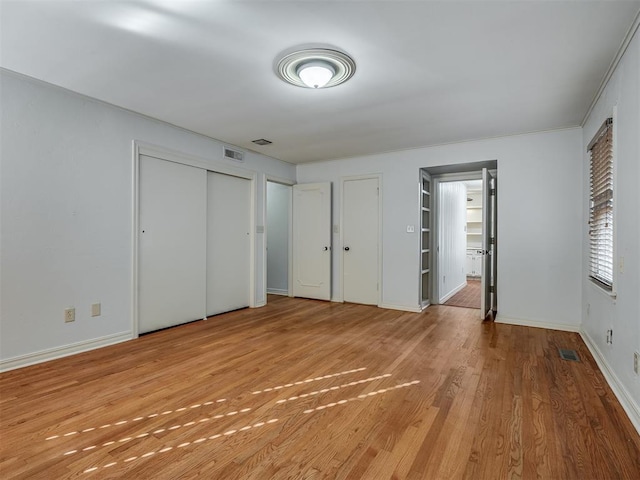 unfurnished bedroom with light wood-type flooring