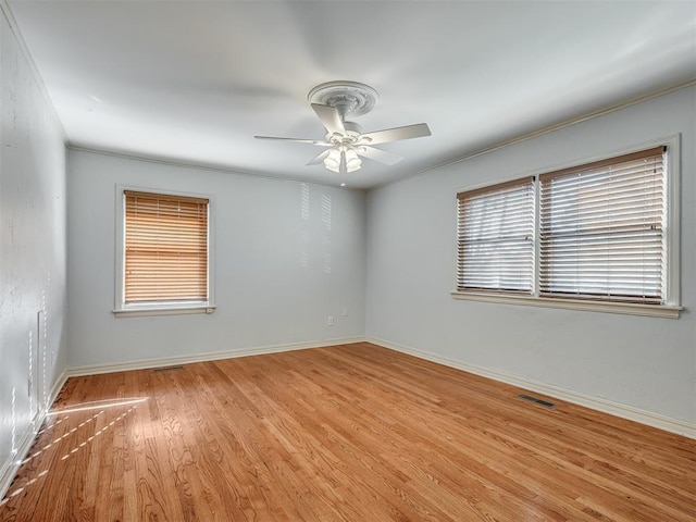 unfurnished room featuring light wood-type flooring and ceiling fan