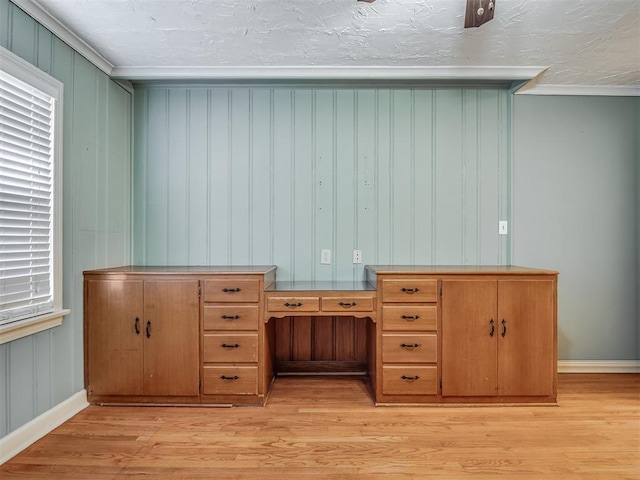 interior space with a healthy amount of sunlight, light hardwood / wood-style flooring, crown molding, and a textured ceiling