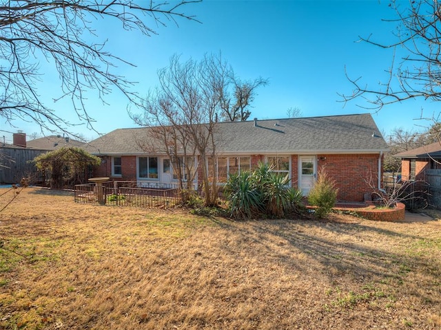 back of house featuring a lawn