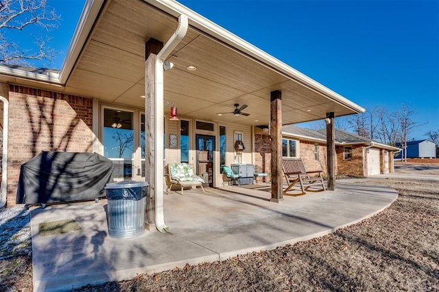 view of patio / terrace featuring ceiling fan and a garage