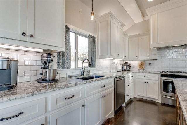 kitchen featuring stainless steel appliances, sink, decorative light fixtures, white cabinets, and backsplash