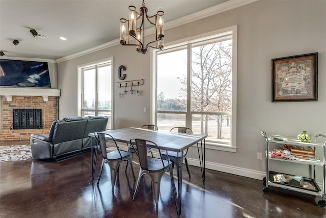 dining room with a fireplace, a chandelier, crown molding, and a healthy amount of sunlight