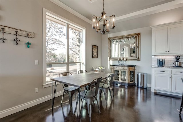 dining room with a notable chandelier and crown molding