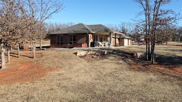 exterior space featuring covered porch and a front lawn