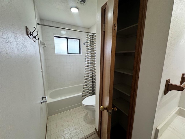 bathroom featuring shower / tub combo and toilet