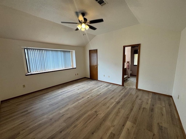 unfurnished bedroom with lofted ceiling, ceiling fan, and light hardwood / wood-style flooring