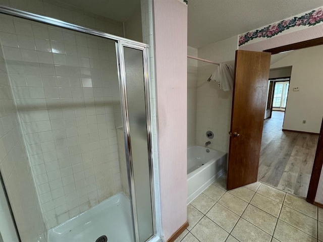 bathroom featuring tile patterned floors and separate shower and tub