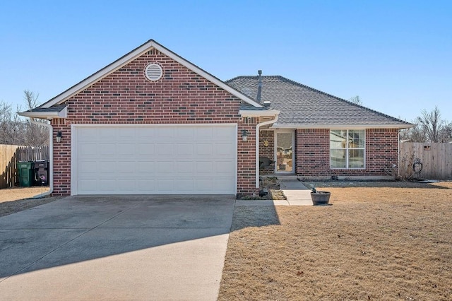 view of front of property featuring a front yard and a garage