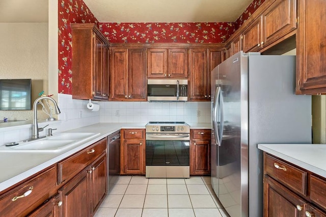 kitchen featuring backsplash, appliances with stainless steel finishes, light tile patterned floors, and sink