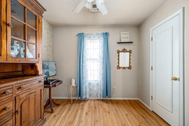 office space with light wood-type flooring and ceiling fan