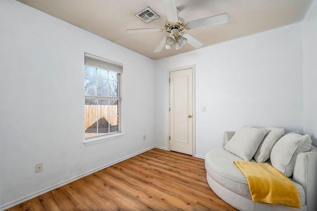 sitting room with ceiling fan and light hardwood / wood-style flooring