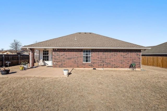 rear view of property featuring a patio and a yard