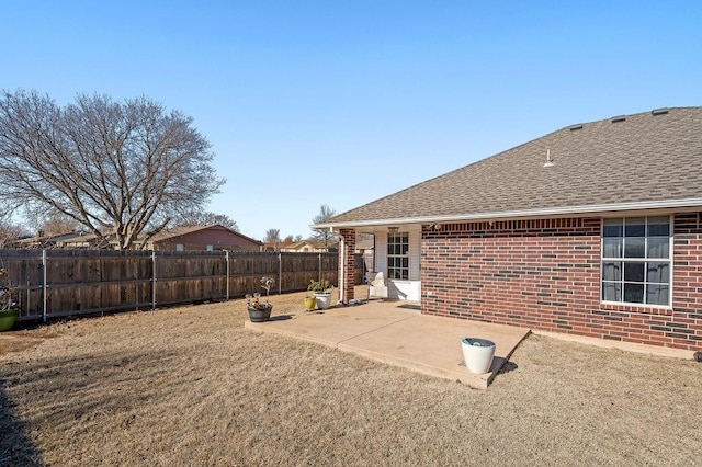 back of house featuring a yard and a patio