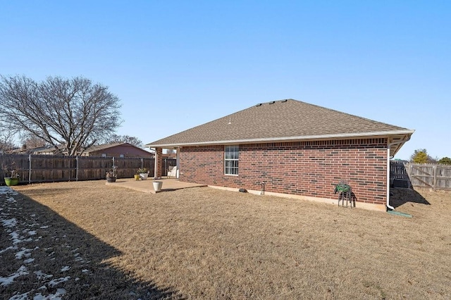 rear view of property with a lawn and a patio area