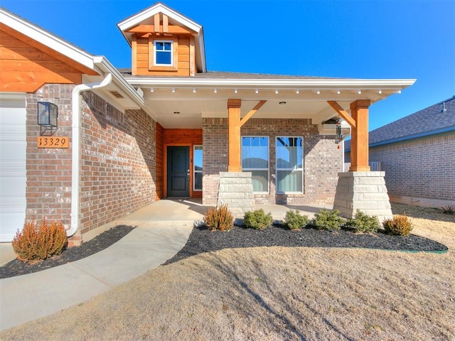 view of exterior entry with a porch