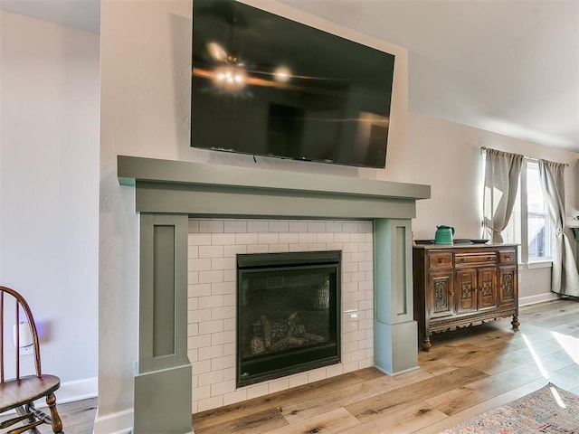 details with a brick fireplace and hardwood / wood-style floors