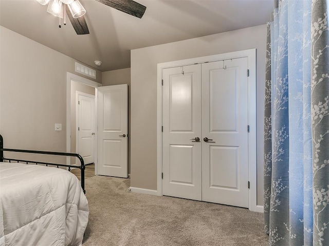 unfurnished bedroom with ceiling fan, light colored carpet, and a closet