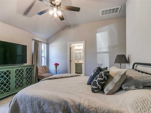 bedroom with vaulted ceiling, ceiling fan, and connected bathroom