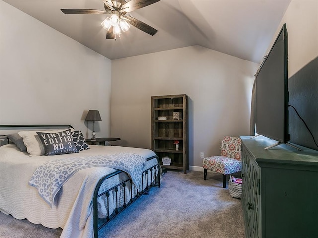 bedroom with ceiling fan, lofted ceiling, and carpet flooring