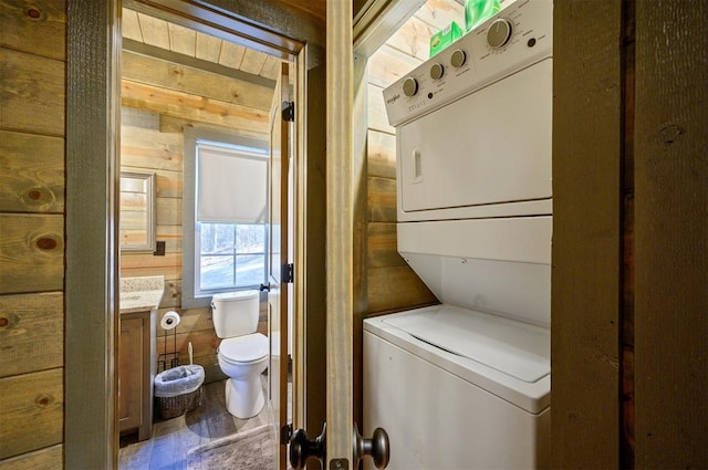 laundry area featuring stacked washer / dryer