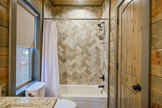 full bathroom with vanity, shower / bathtub combination with curtain, and toilet