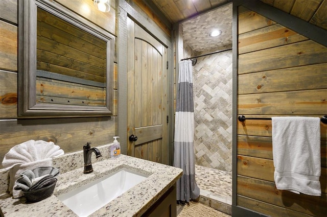 bathroom with vanity, wooden walls, wood ceiling, and a shower with shower curtain