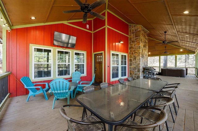 deck with a hot tub and ceiling fan